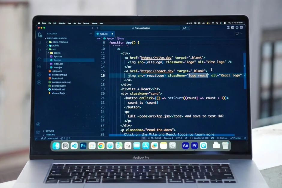 Dual monitors on a desk, showcasing web design in a modern office setting.